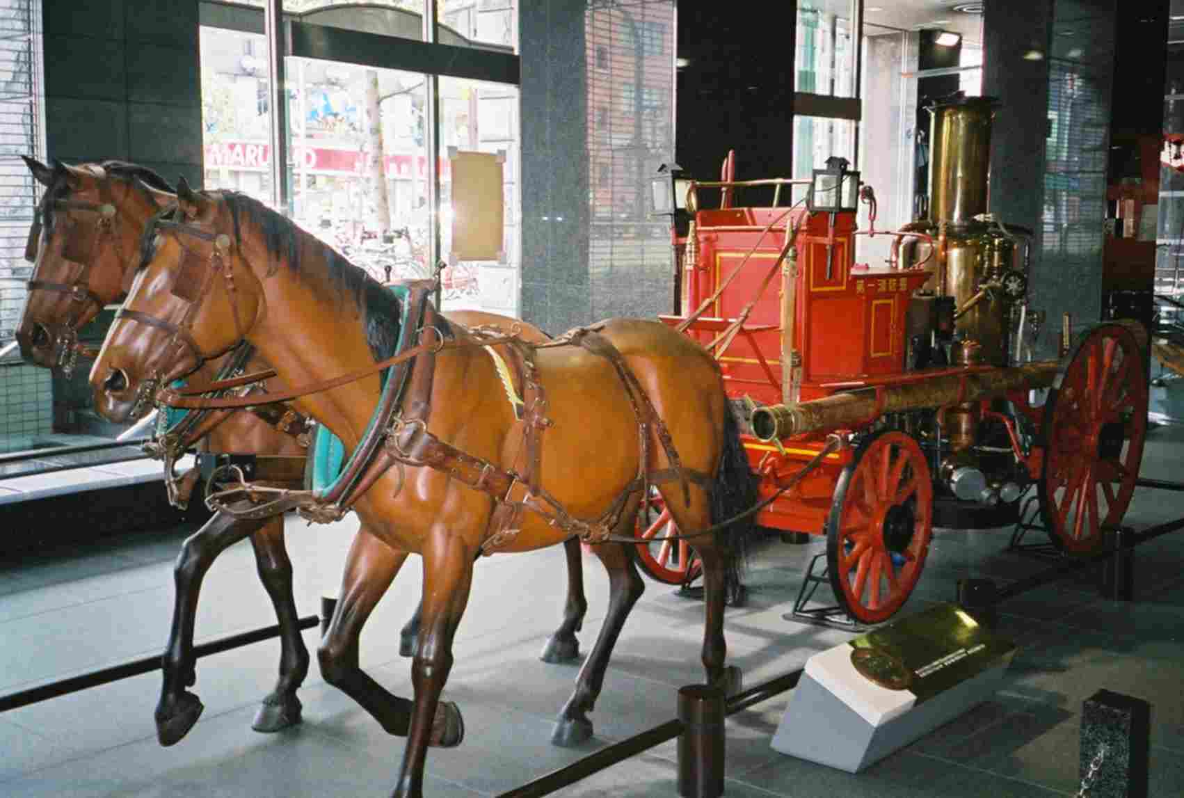 Horses pulling a steam pump
